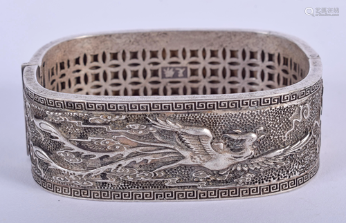 A CHINESE WHITE METAL BANGLE. 7 cm wide.