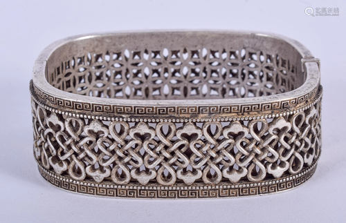 A CHINESE WHITE METAL BANGLE. 7 cm wide.