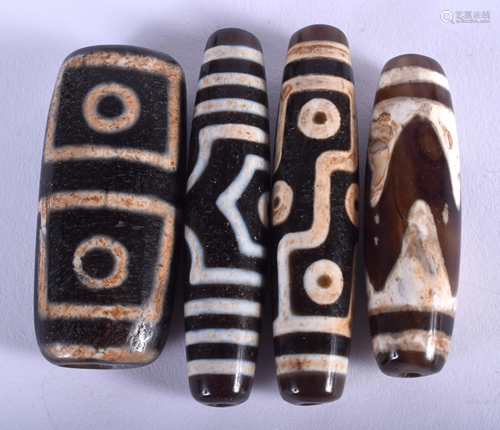 FOUR CHINESE TIBETAN ZHU BEADS. Largest 4.5 cm …