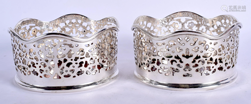 A PAIR OF SILVER PLATED COASTERS. 13 cm wide.