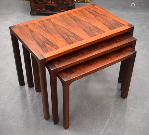 A NEST OF THREE STYLISH HARDWOOD TABLES.…