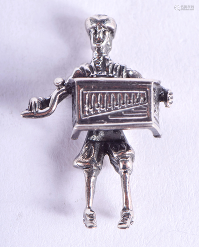 A SILVER ACCORDION PLAYER. 2.5 cm high.