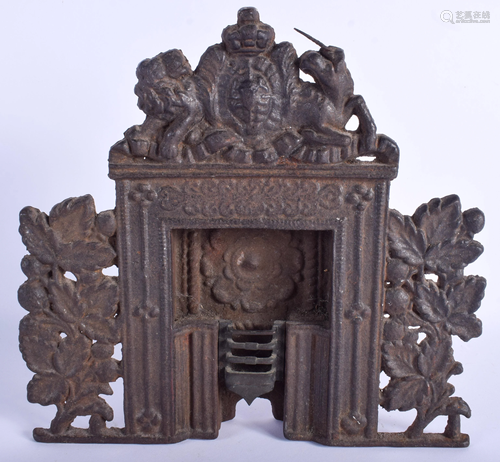 AN ANTIQUE CAST IRON MINIATURE FIREPLACE. …