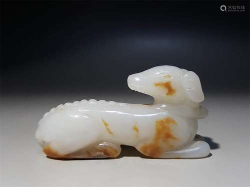 A CHINESE CARVED HETIAN JADE DOG ORNAMENT