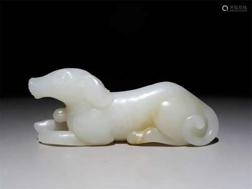 A CHINESE CARVED HETIAN JADE DOG ORNAMENT