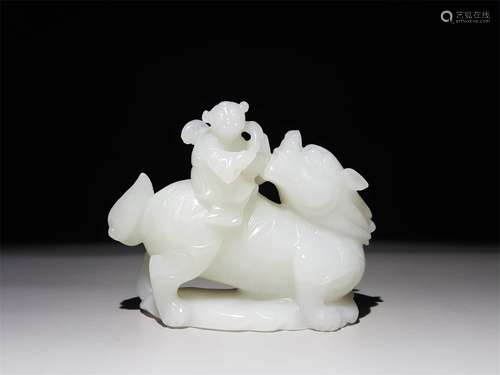 A CHINESE CARVED HETIAN JADE ORNAMENT