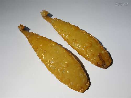 A PAIR OF QING DYNASTY CARVED YELLOW JADE CORD HOOKS