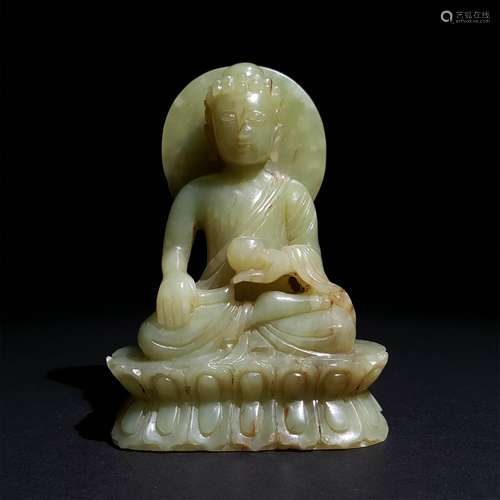 A QING DYNASTY CARVED YELLOW JADE SAKYAMUNI STATUE