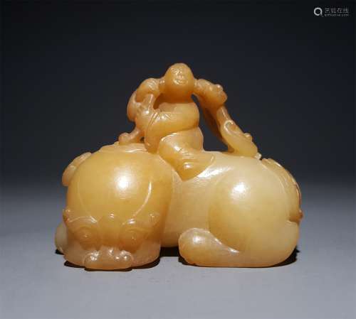 A CHINESE CARVED HETIAN JADE ORNAMENT, CHILD RIDE A BEAST