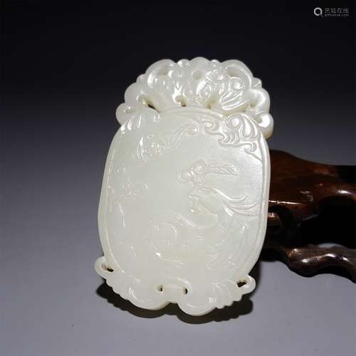 A CHINESE CARVED HETIAN JADE PENDANT