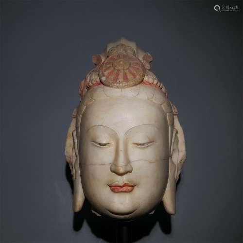 A WARRING STATES PERIOD CARVED WHITE JADE BUDDHA BEAD
