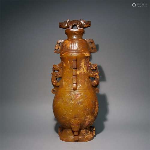 A WARRING STATES PERIOD CARVED YELLOW JADE BOTTLE