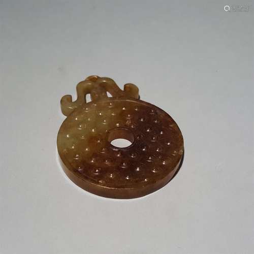 A WARRING STATES PERIOD CARVED 
WHEEL JADE