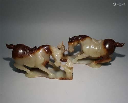 A PAIR OF TANG DYNASTY CARVED JADE HORSE ORNAMENTS