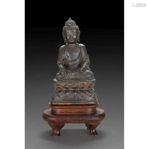 STATUTE OF BUDDHA SHAKYAMUNI in bronze with a dark…