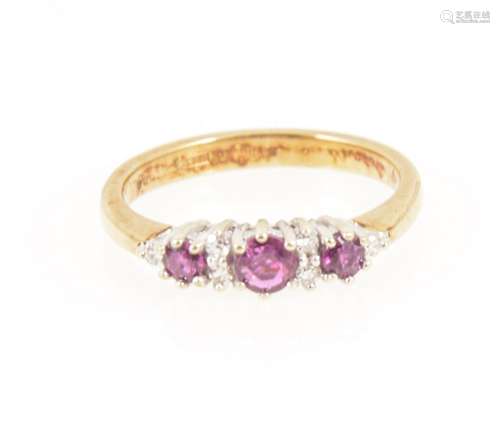 A ruby and diamond half hoop ring.