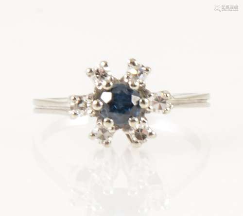 A sapphire and diamond circular cluster ring.