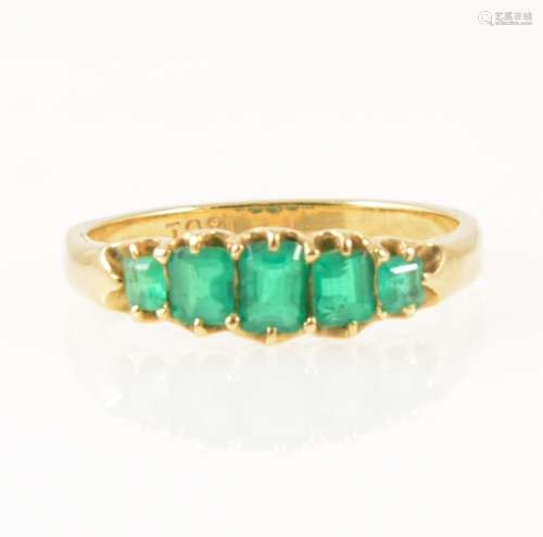 An emerald five stone half hoop ring.