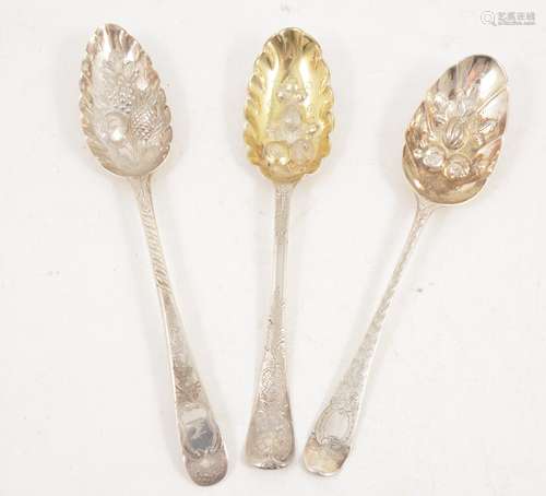 Three Georgian silver berry spoons with later decoration.