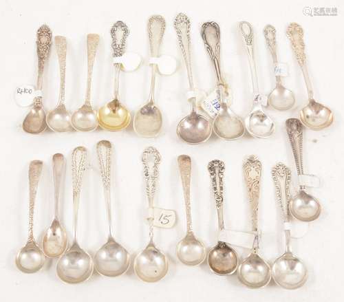 Nineteen decorative silver and white metal salt spoons.