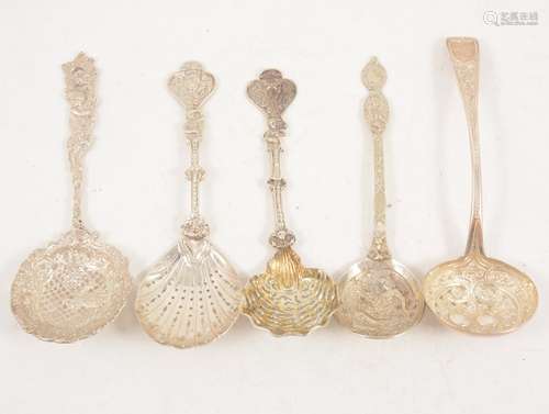 Five large ornate silver sugar sifting spoons.