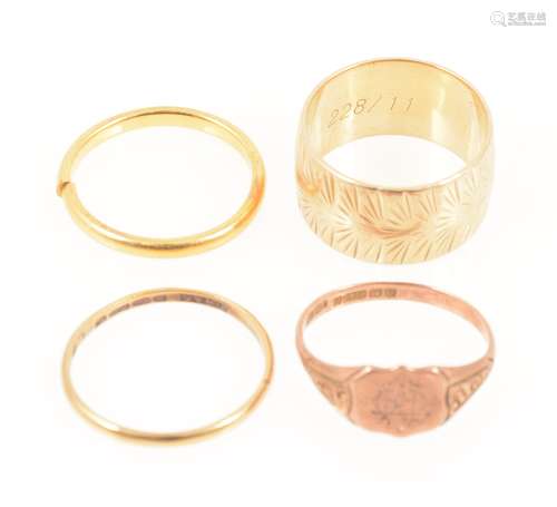 Three gold wedding bands and a rose gold signet ring.