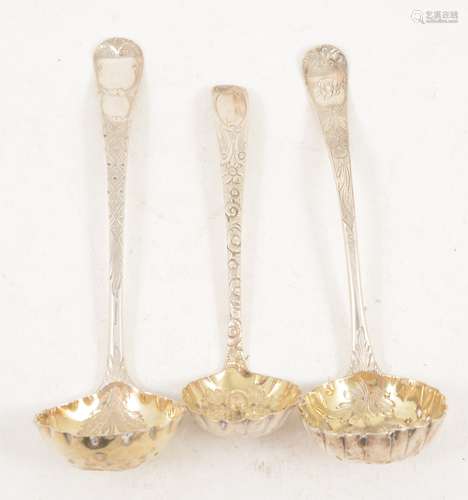 Three silver sugar sifting spoons with gilded berry bowls.