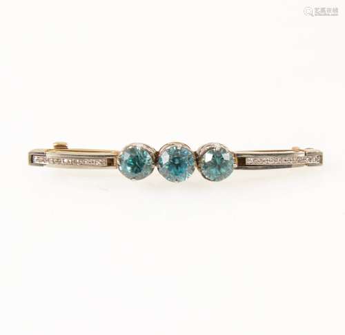 A heat treated blue zircon and diamond brooch.