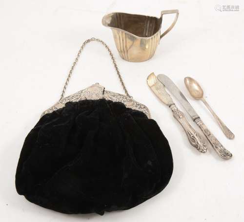 A silver cream jug, evening bag (clasp damaged), flatware.