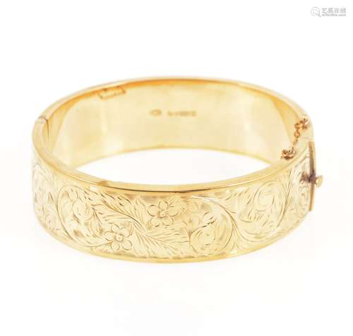 A 9 carat yellow gold half hinged bangle.