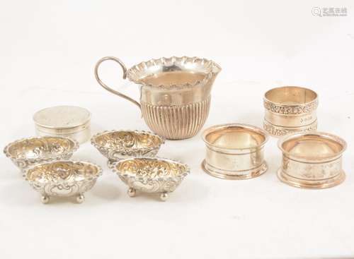 A Victorian silver cup, three napkin rings, four salts and trinket pot.