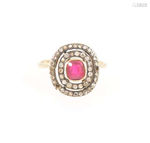 A diamond ring with ruby coloured stone to centre