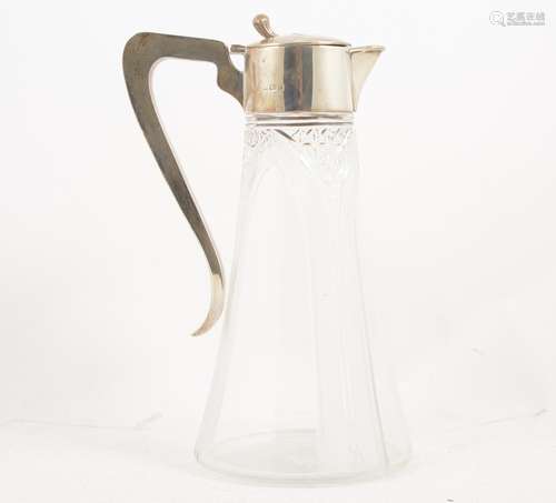 An Edwardian cut-glass and silver mounted claret jug