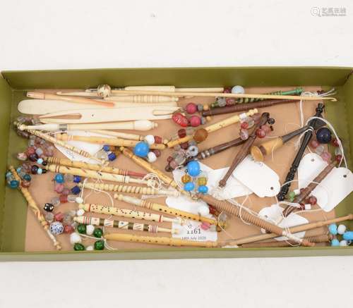 A collection of bone and wooden pillow lace bobbins, hooks etc.