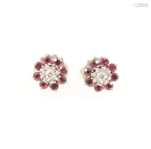 A pair of ruby and diamond ear studs.