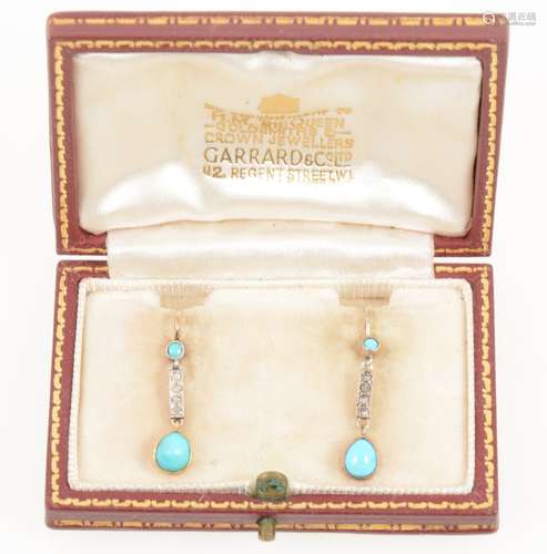 A pair of turquoise and diamond drop earrings.