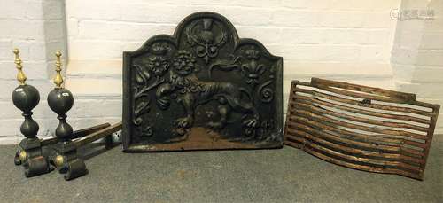 A cast iron fireback, fire grate and pair of fire dogs