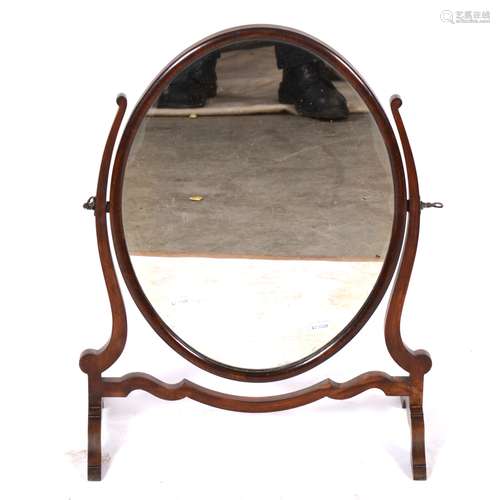 A mahogany oval toilet mirror