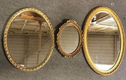 Three oval gilt framed mirrors, largest being 84cm wide.