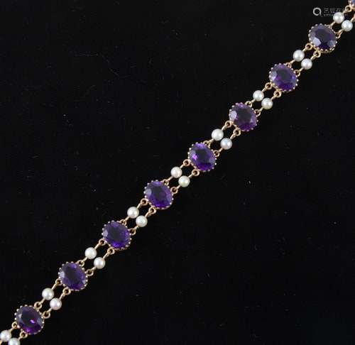 An amethyst and pearl bracelet, strung with ten oval cut stones