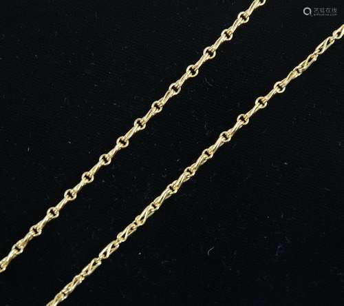 A yellow metal fancy link chain.