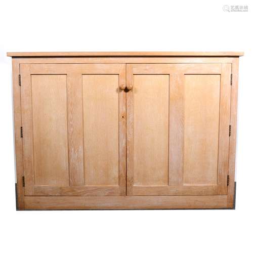 A limed oak two-door linen cupboard