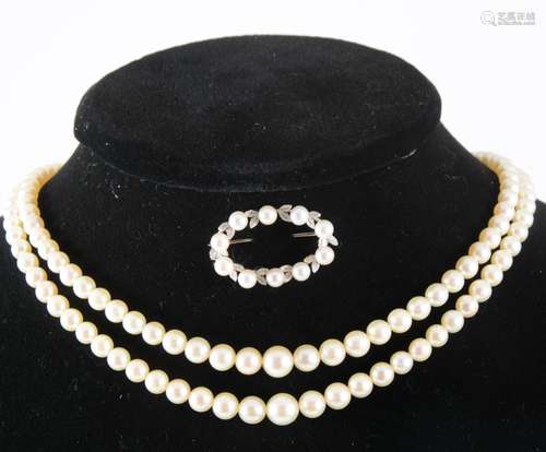 A cultured pearl two row necklace and pearl set brooch.