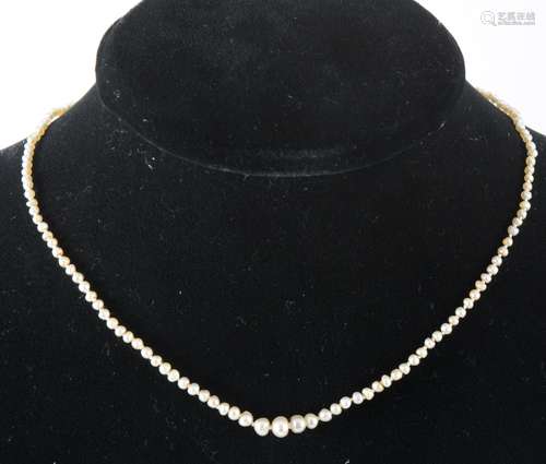 A pearl necklace with diamond set clasp.