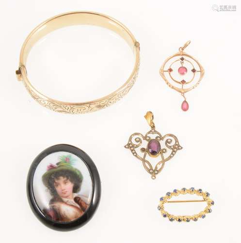 A collection of vintage pendants, brooch and bangle.