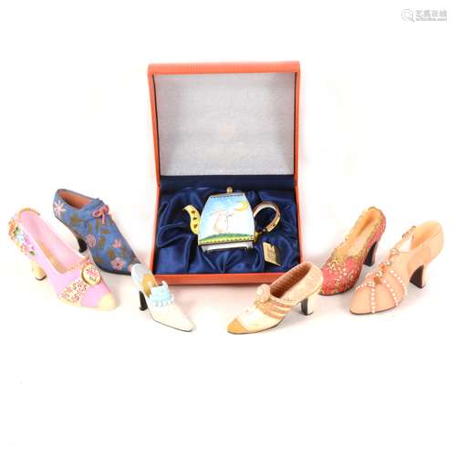 A collection of miniature decorative shoes, miniatyre enamelled teapot, and household linen