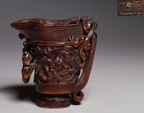 A NIUJIAO CARVED DRAGON PATTERN CUP