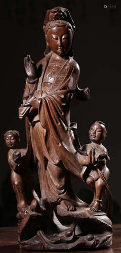 A LONGYAN WOOD CARVED GUANYIN STATUE