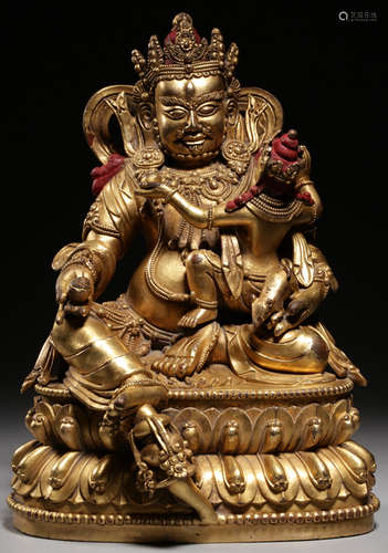 A GILT BROZNE CASETD YELLOW JAMBHALA STATUE