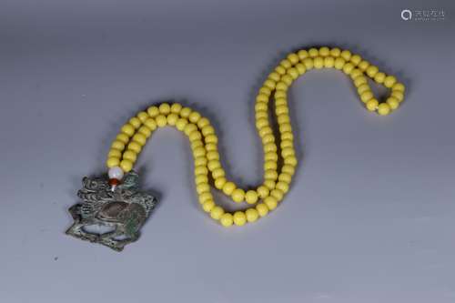 ARCHAIC BRONZE CAST 'QILIN' PENDANT WITH YELLOW BEAD NECKLACE